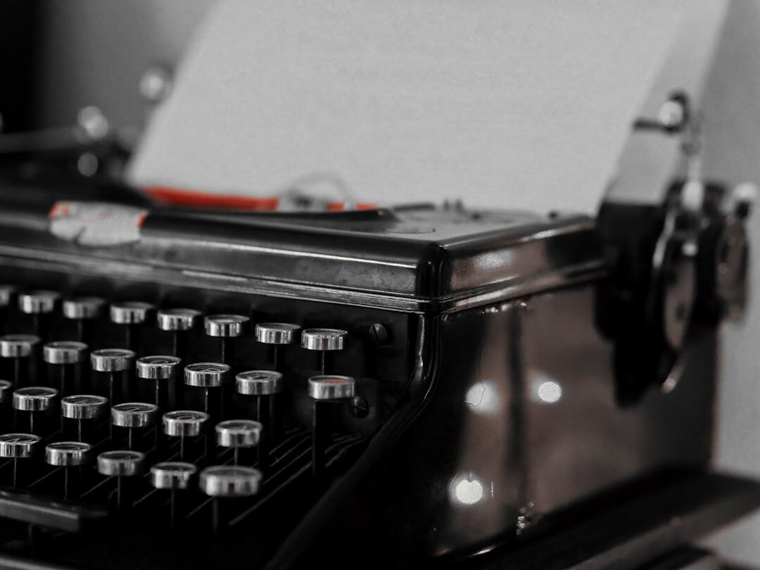 Close-up of a vintage black typewriter with a sheet of paper loaded