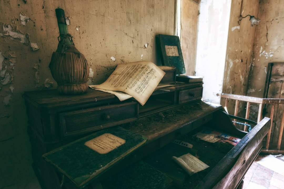 writer at desk with old books